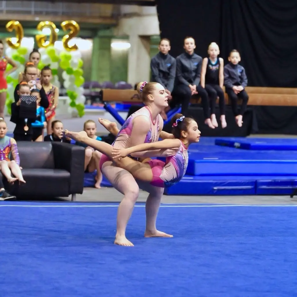 Acrobatic gymnastics pair performing a wrap balance element