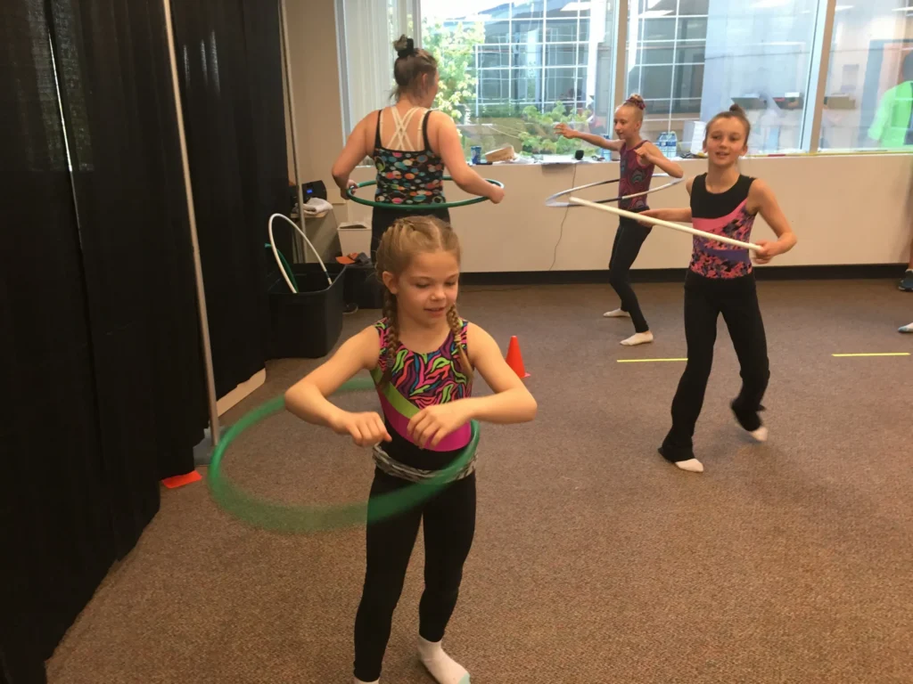 Athletes training acrobatic skills on the floor at Edmonton Acrobatic Gymnastics