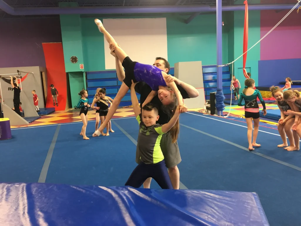 Gymnasts working on tumbling skills during a recreational class