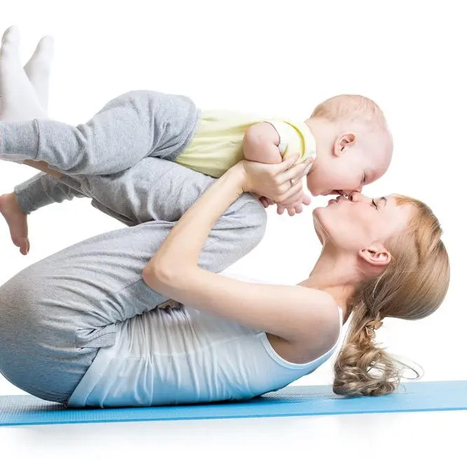 Parent supporting their baby during a parent and baby gymnastics class
