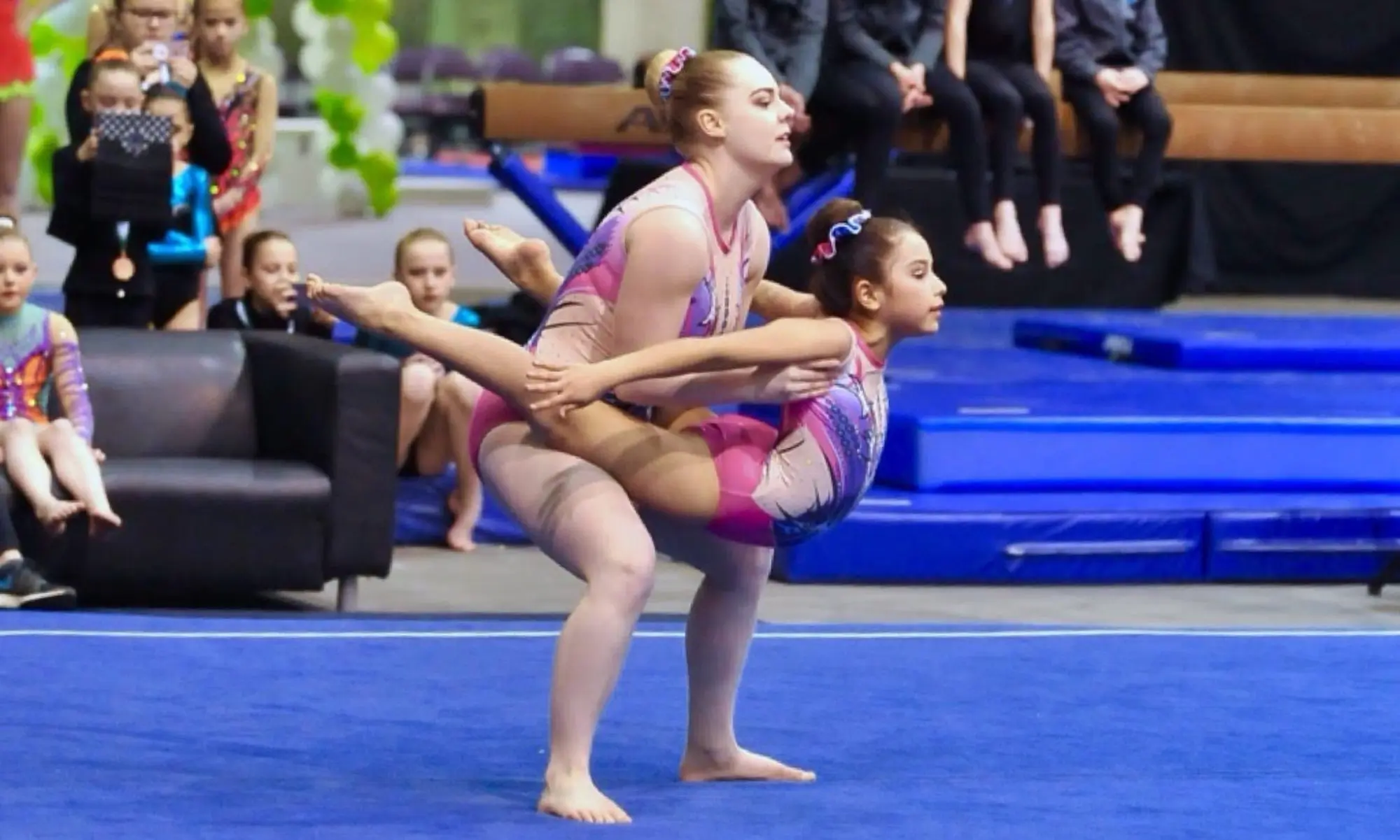 Young acrobatic gymnasts training together in the Edmonton Acrobatic Gymnastics gym